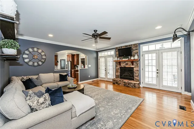 a living room with furniture and a fireplace with wooden floor