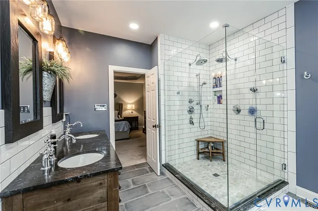 a bathroom with a shower sink and mirror