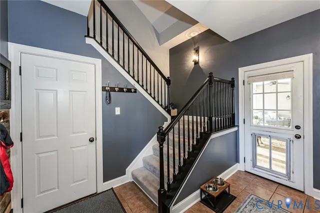 a view of an entryway with wooden floor and stairs