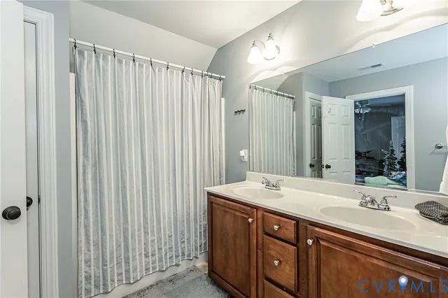 a bathroom with a double vanity sink and a mirror