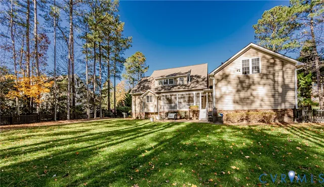 a view of a big house with a big yard and large trees