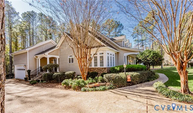 a front view of a house with a yard and potted plants