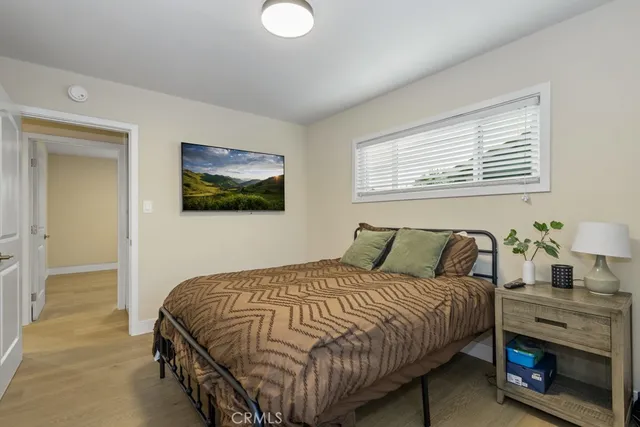 a bedroom with a bed and a ceiling fan