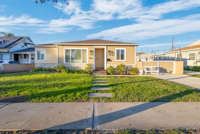 a view of a house with a big yard and large trees