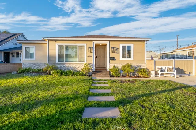 a front view of a house with a garden