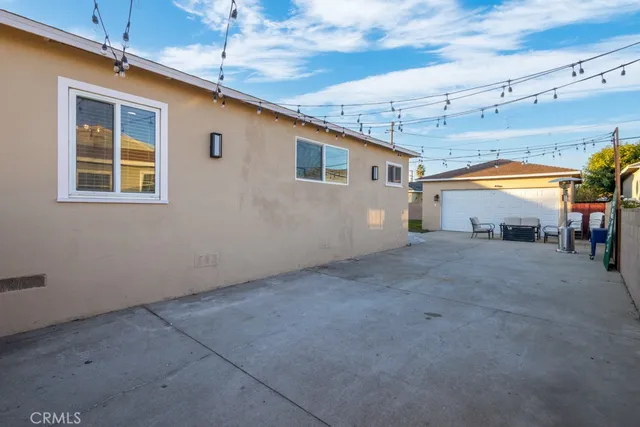 a backyard of a house with table and chairs
