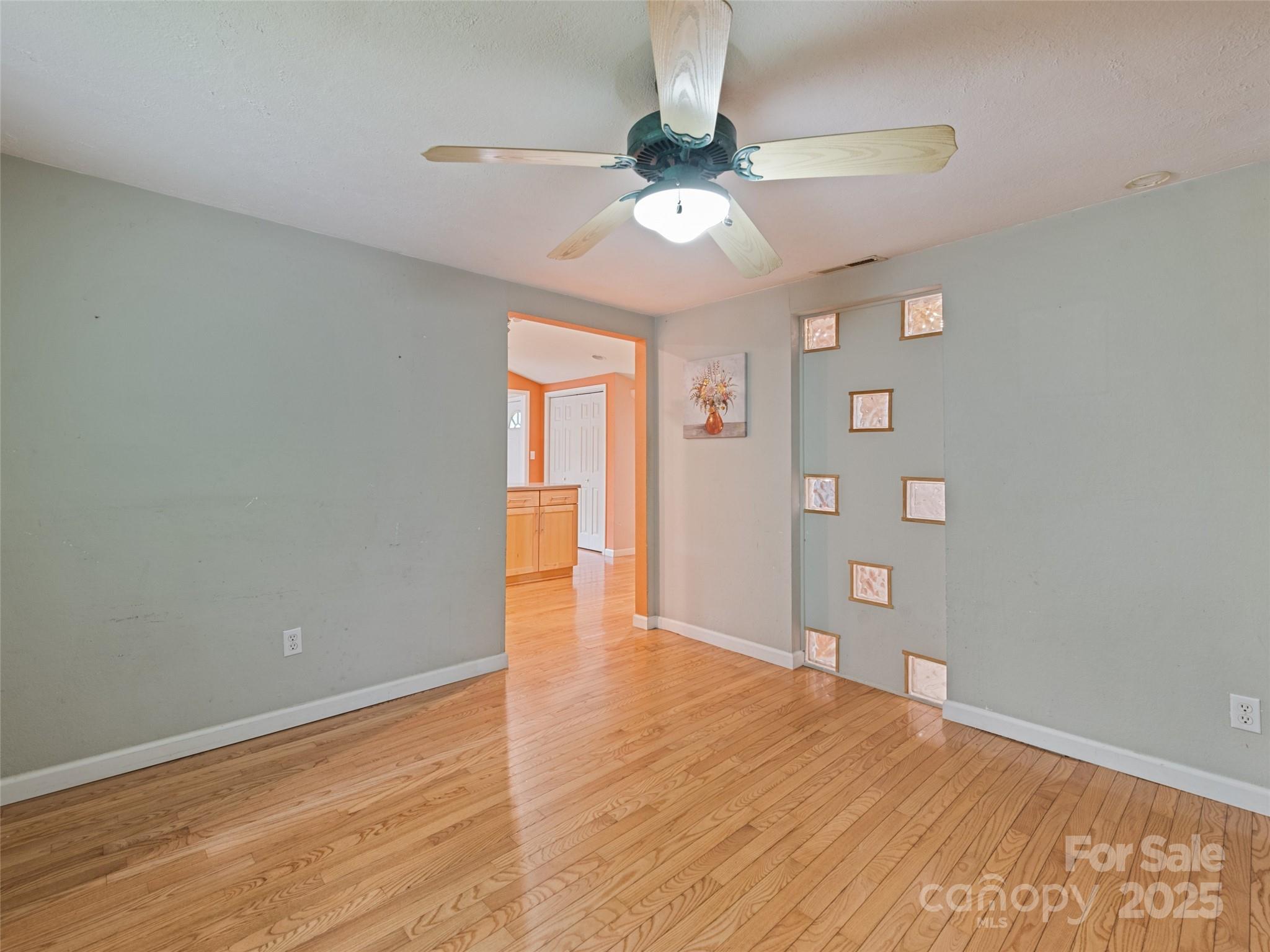 3383 Thickety Road Clyde, NC 28721 - Photo 13 of 33 wooden floor in an empty room with a window