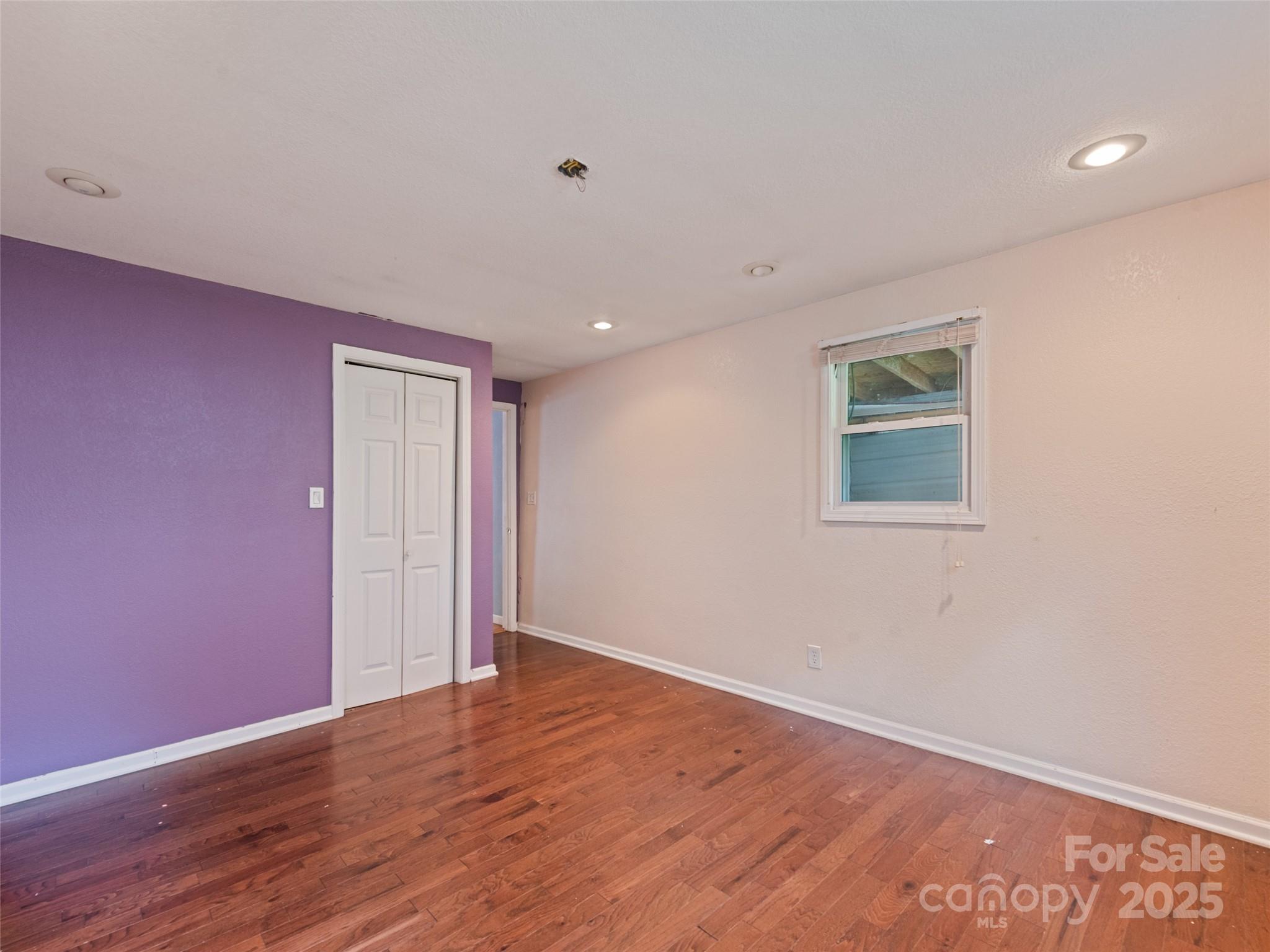 3383 Thickety Road Clyde, NC 28721 - Photo 15 of 33 a view of an empty room with wooden floor and a window
