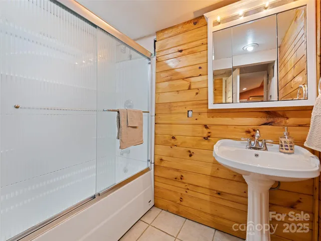 a view of a big room with wooden floor and windows