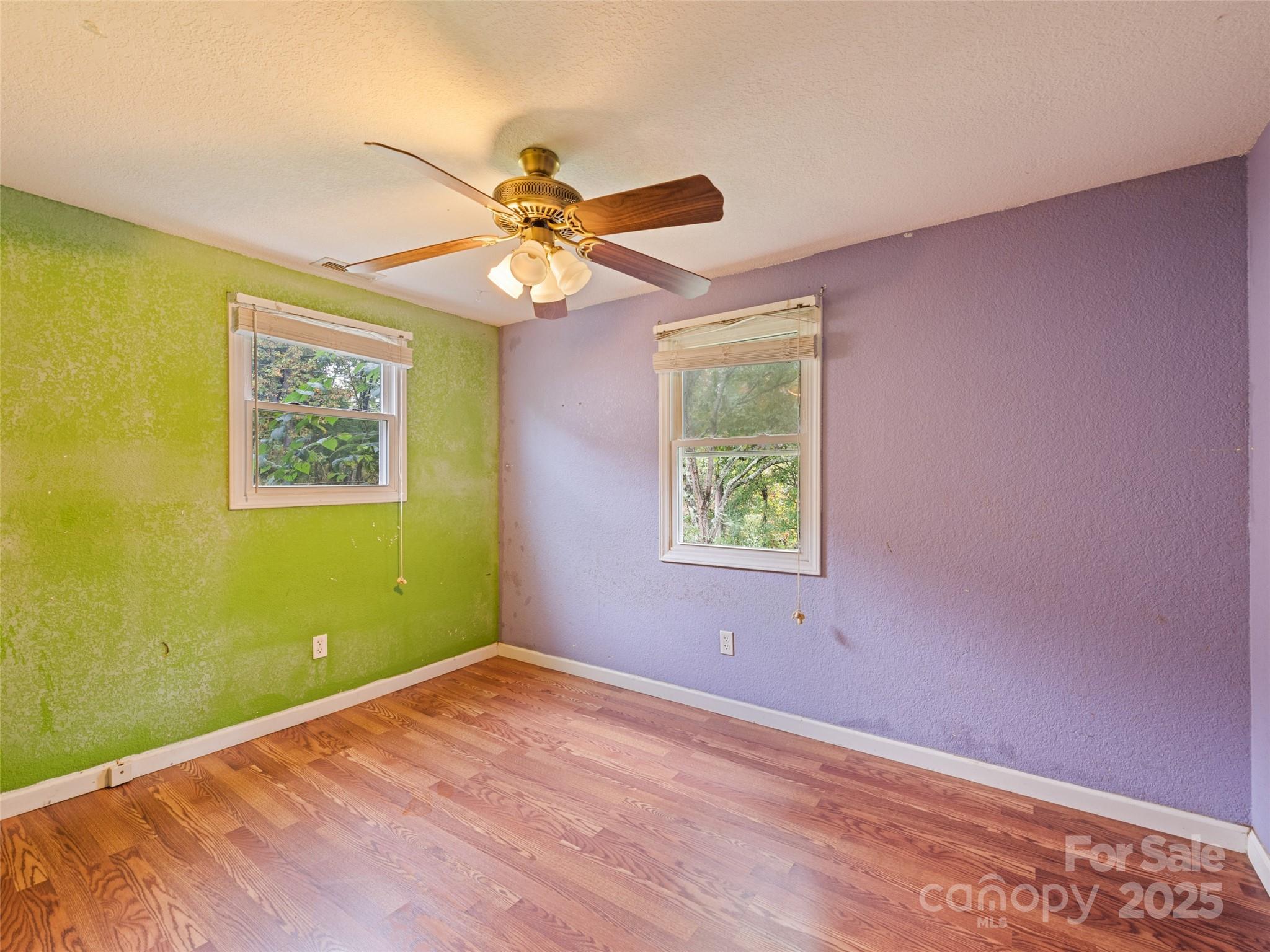 3383 Thickety Road Clyde, NC 28721 - Photo 17 of 33 a view of a big room with wooden floor and windows
