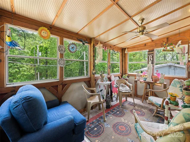a living room with furniture and a floor to ceiling window