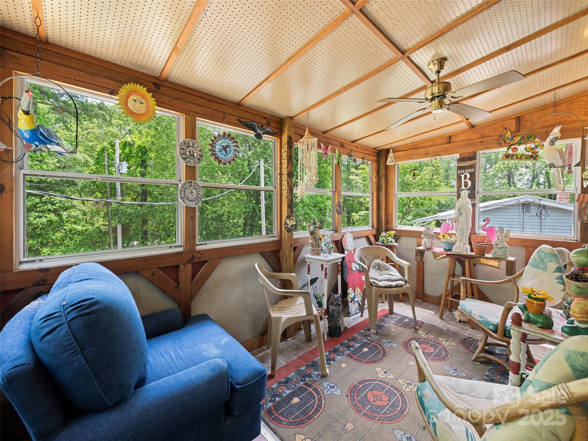 3383 Thickety Road Clyde, NC 28721 - Photo 21 of 33 a living room with furniture and a floor to ceiling window