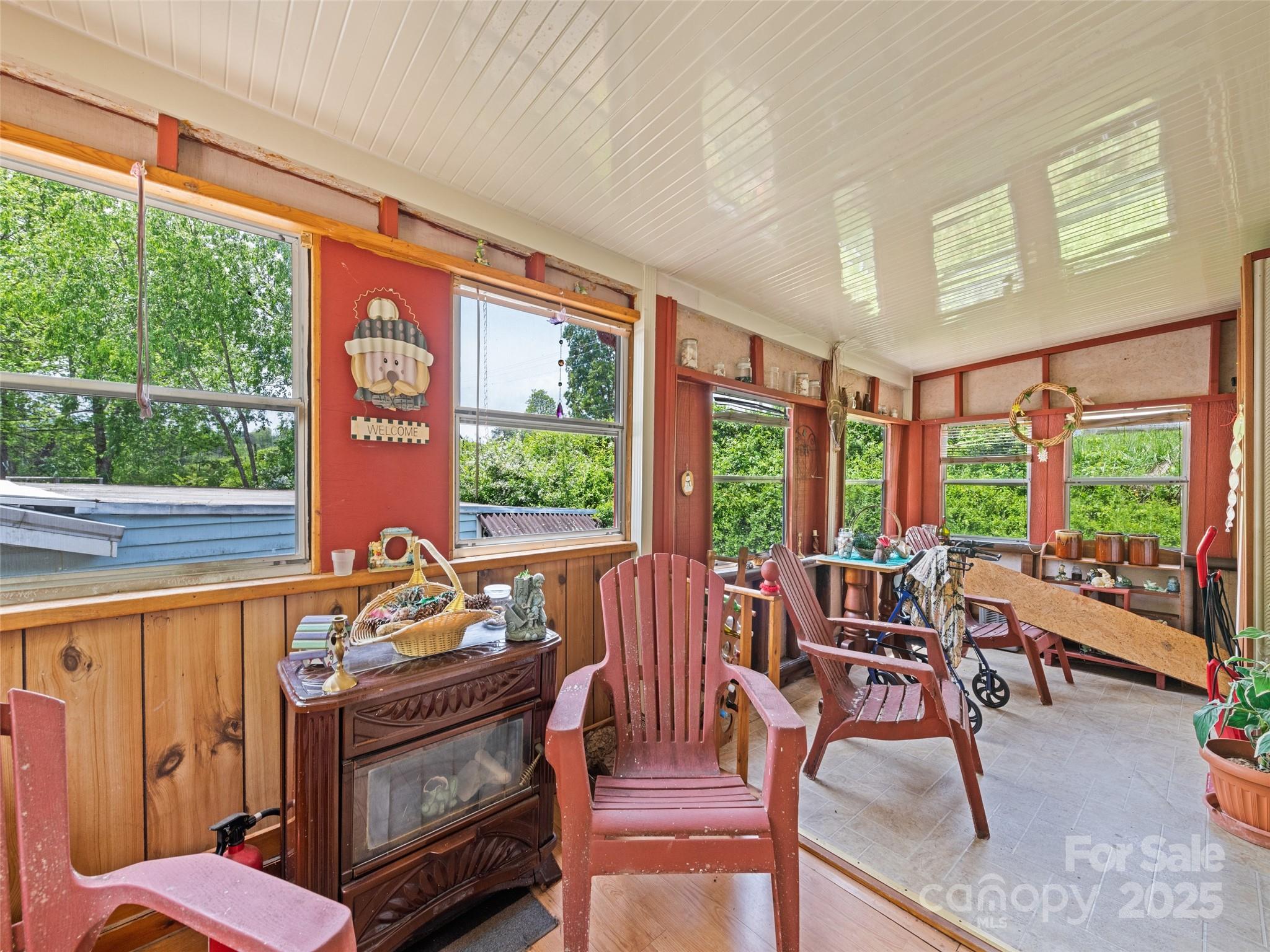 3383 Thickety Road Clyde, NC 28721 - Photo 22 of 33 a living room with furniture and a floor to ceiling window