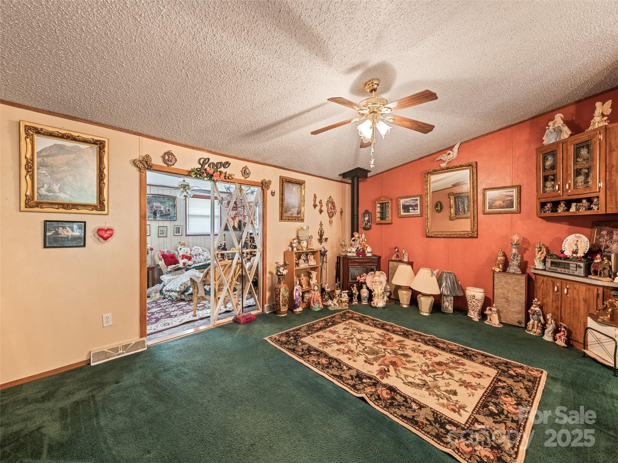 3383 Thickety Road Clyde, NC 28721 - Photo 27 of 33 a bed room with a bed and a chandelier