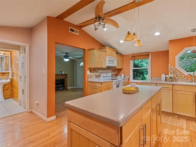 a kitchen with a sink a counter top space and stainless steel appliances