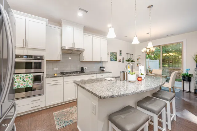 a kitchen with sink stove and refrigerator