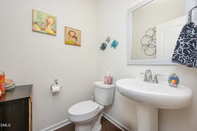 a bedroom with a bed and a flat tv screen on dresser