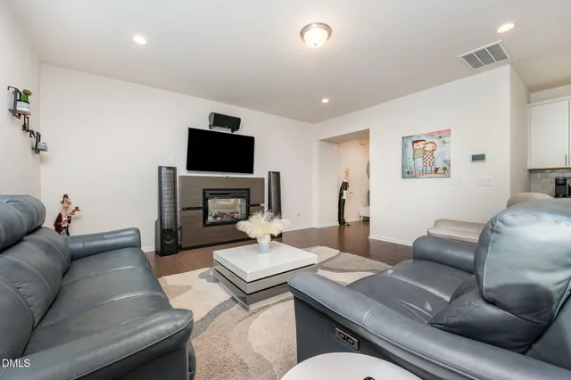 a dining room with furniture and wooden floor