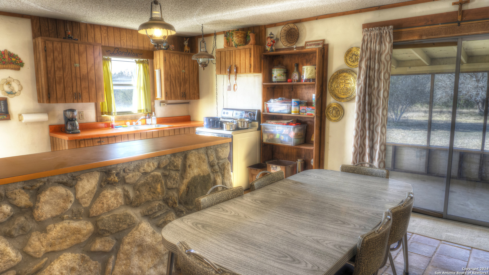 22 Squirrel Bend Uvalde, TX 78801 - Photo 24 of 47 a large kitchen with kitchen island a stove a sink and a dining table view