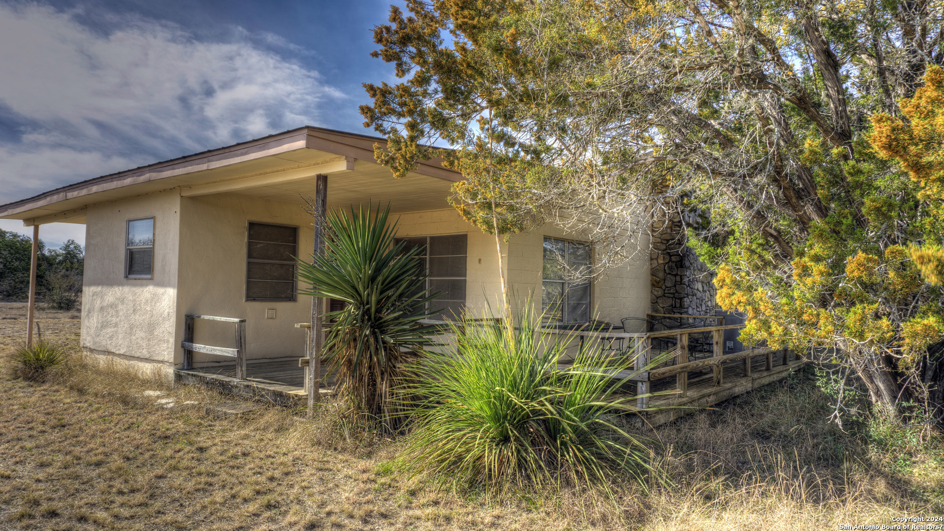 22 Squirrel Bend Uvalde, TX 78801 - Photo 4 of 47 a yellow house with a tree in front of it