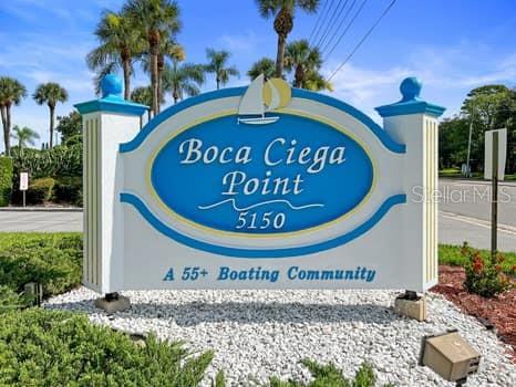 146 Boca Ciega Point Boulevard South, Unit 146 St. Petersburg, FL 33708 - Photo 2 of 14 a sign that is next to a building