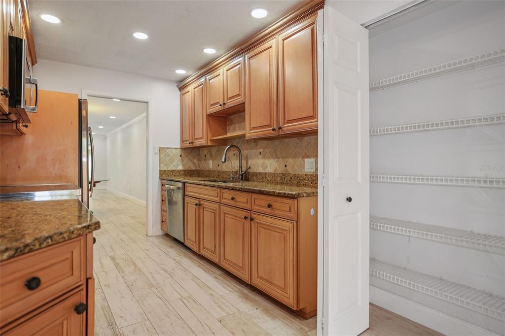 146 Boca Ciega Point Boulevard South, Unit 146 St. Petersburg, FL 33708 - Photo 6 of 14 a kitchen with granite countertop cabinets stainless steel appliances and a counter space