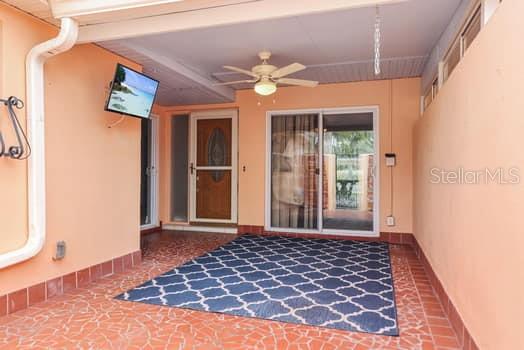 146 Boca Ciega Point Boulevard South, Unit 146 St. Petersburg, FL 33708 - Photo 10 of 14 a view of a hallway with wooden floor and a ceiling fan