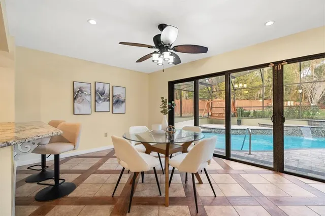 a dining room with furniture a rug and a large window