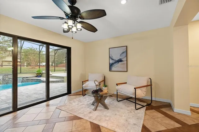 a living room with couch and large windows