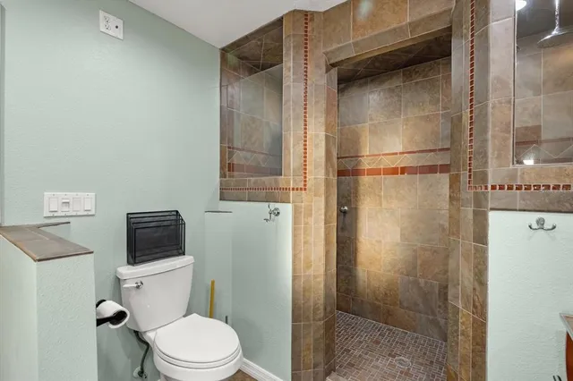 a white toilet sitting next to a bathroom sink