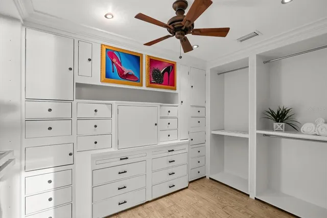 a living room with cabinets and wooden floor