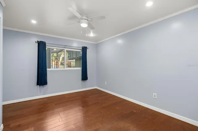 an empty room with closet and a ceiling fan