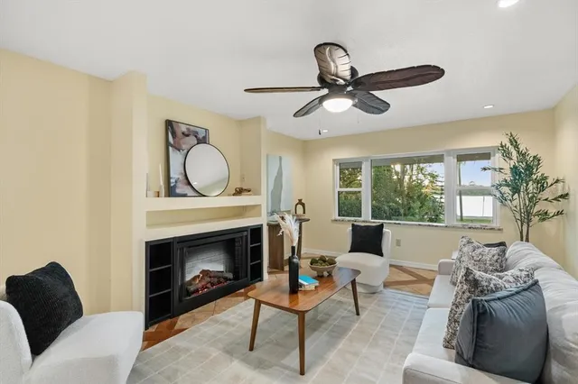 a living room with furniture a rug and a fireplace