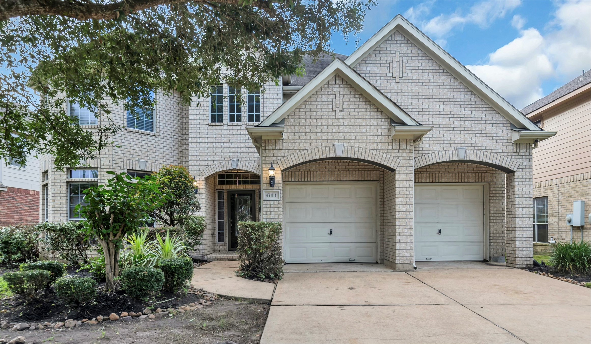 611 River Delta Lane Rosenberg, TX 77469 - Photo 1 of 39 a front view of a house with garden