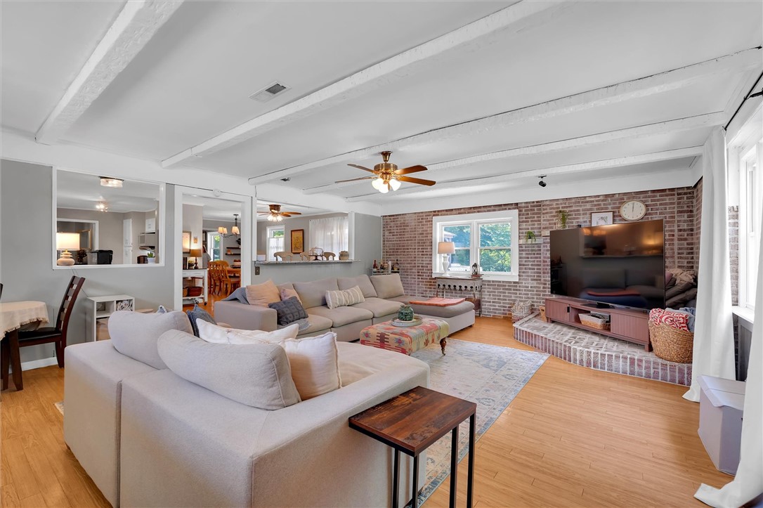 1815 Pearman Dairy Road Anderson, SC 29625 - Photo 12 of 35 Exposed brick accents and a spacious layout define this comfortable gathering area, flowing into a bright dining space.