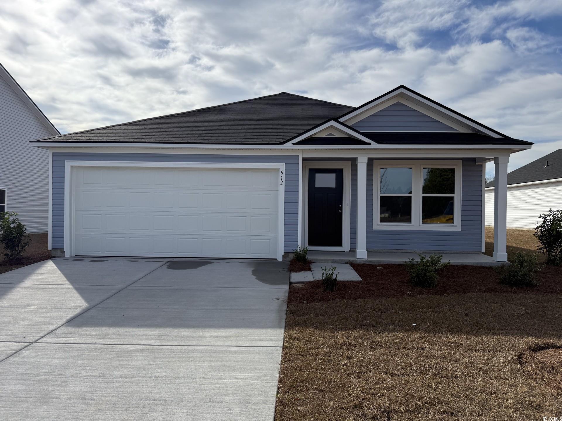 512 Runaway Train Drive Loris, SC 29569 - Photo 1 of 18 Ranch-style house with driveway, a porch, and an attached garage