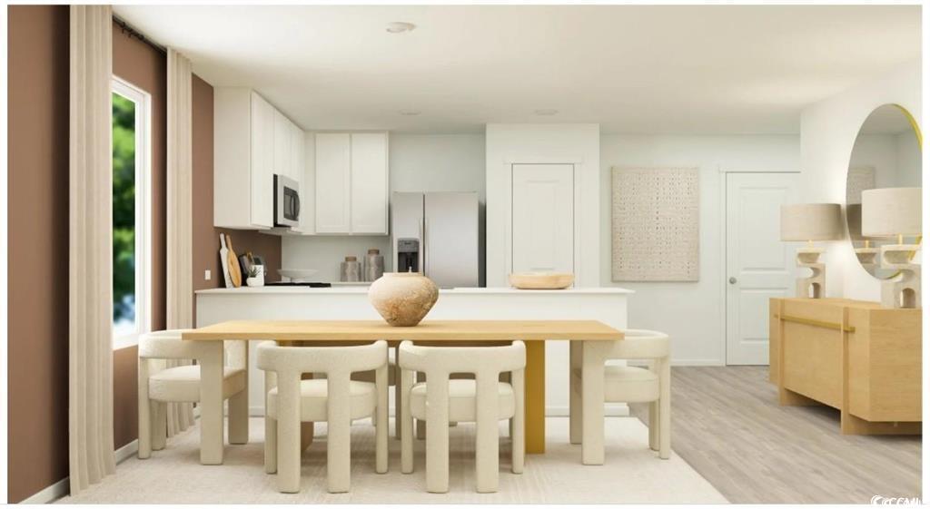 512 Runaway Train Drive Loris, SC 29569 - Photo 8 of 18 Kitchen with appliances with stainless steel finishes, light countertops, white cabinetry, a peninsula, and light wood-style floors