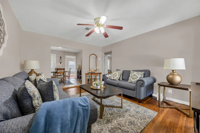 a living room with furniture and wooden floor