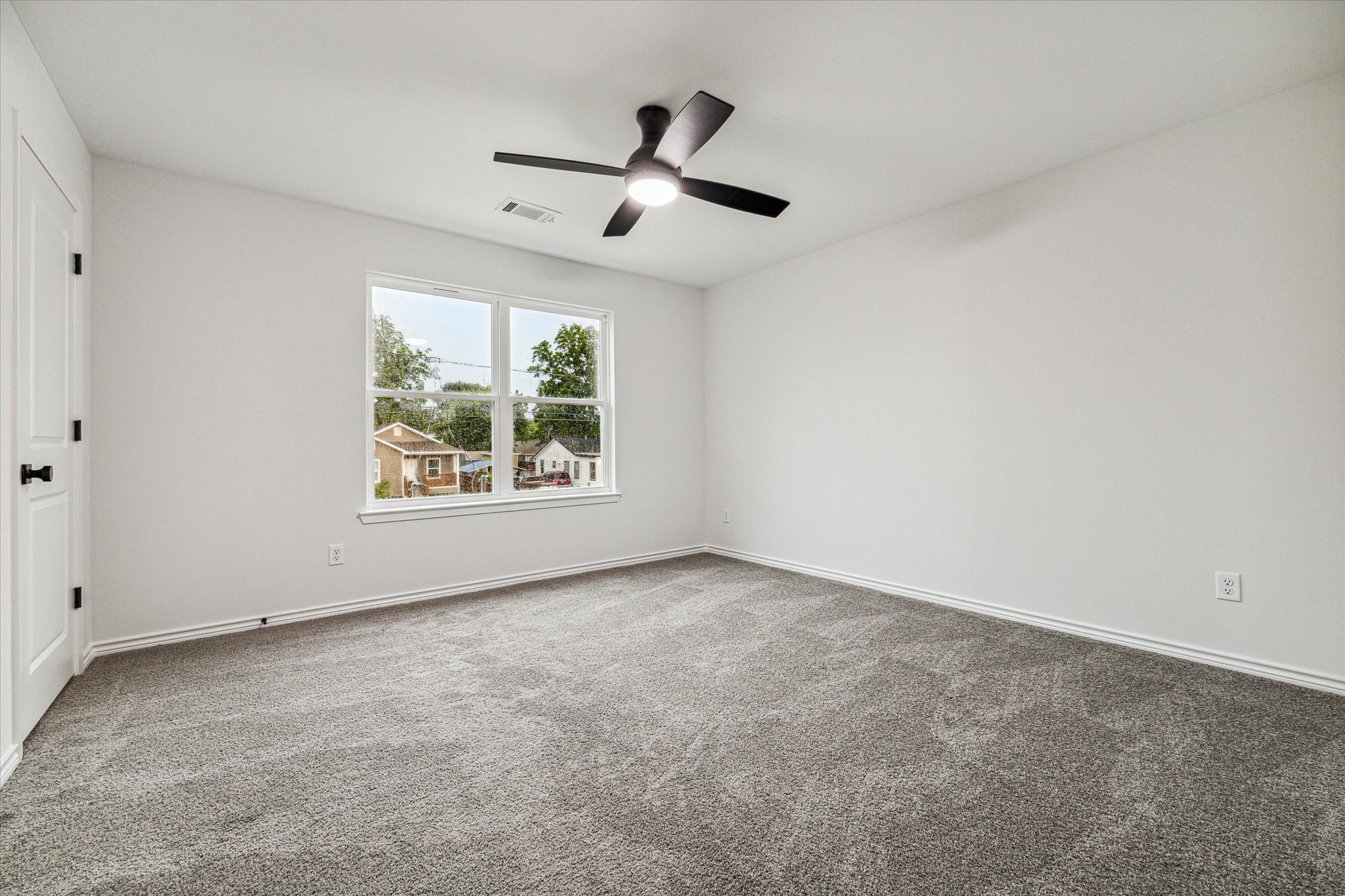 976 Marjorie Street, Unit 2 Houston, TX 77088 - Photo 6 of 11 an empty room with windows and ceiling fan