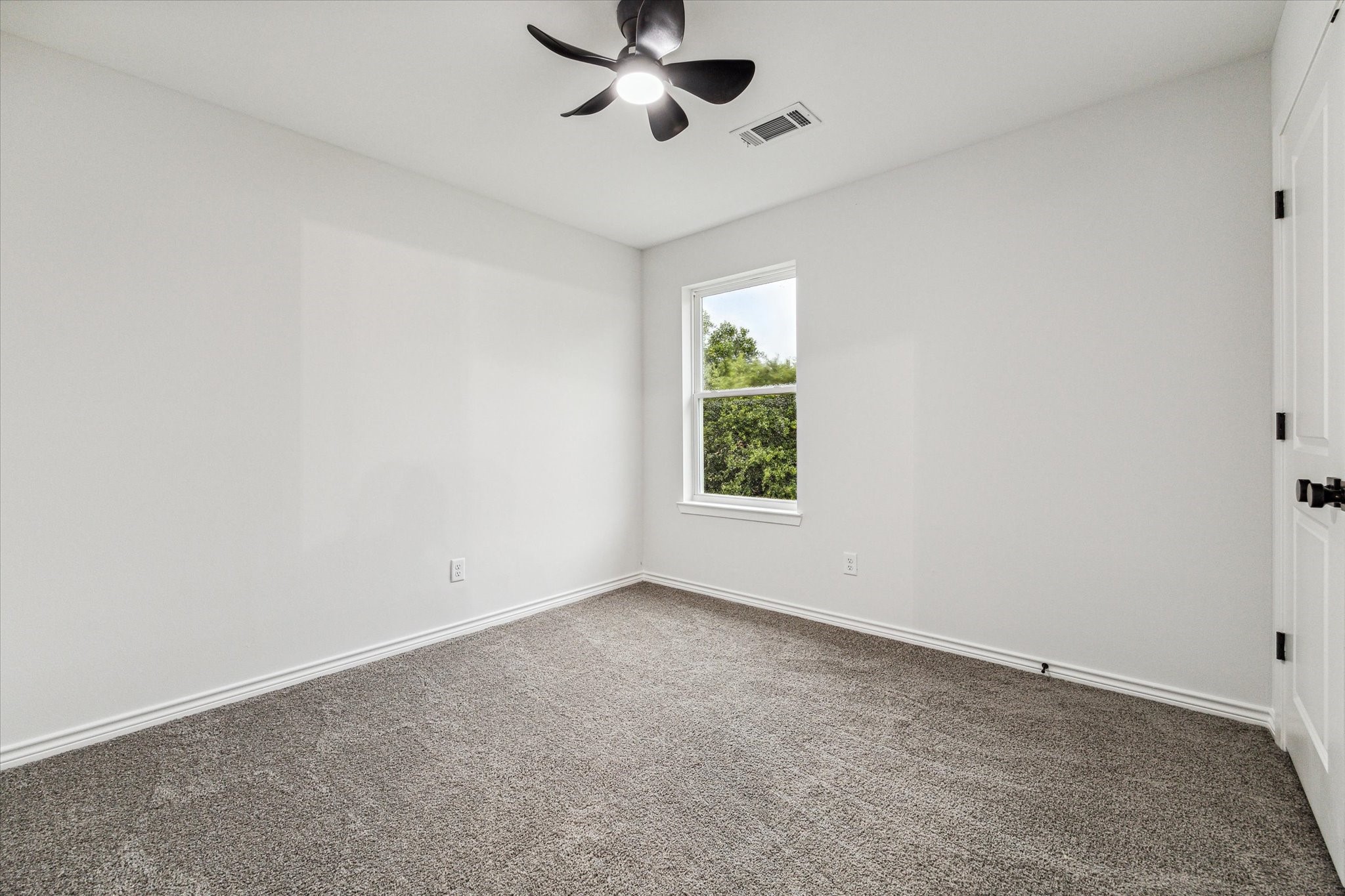 976 Marjorie Street, Unit 2 Houston, TX 77088 - Photo 8 of 11 an empty room with windows and fan