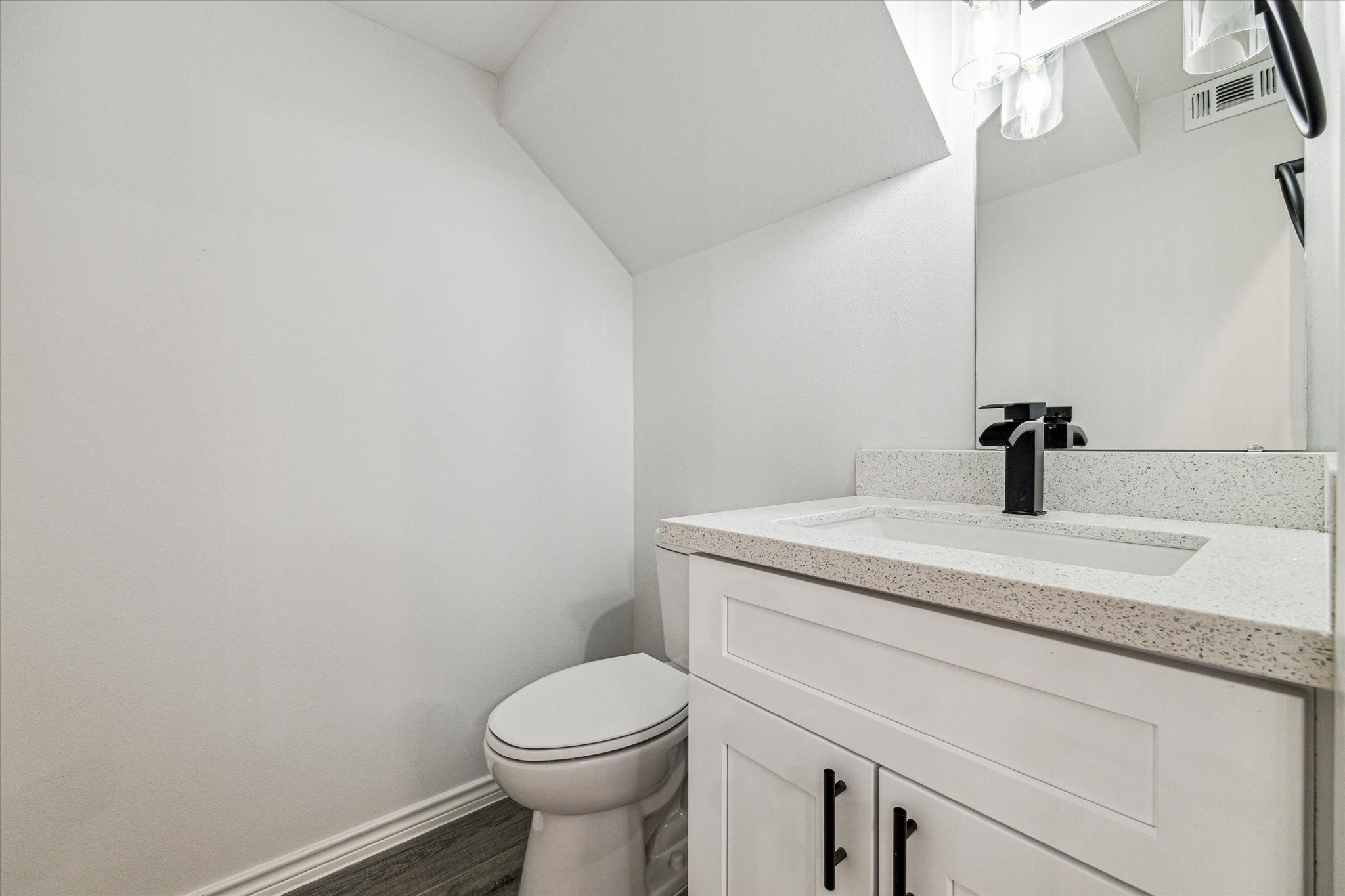 976 Marjorie Street, Unit 2 Houston, TX 77088 - Photo 9 of 11 a bathroom with a granite countertop toilet and sink