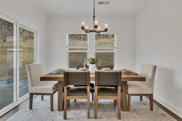 a view of a dining room with furniture window and outside view