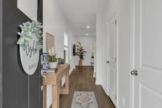 a view of a hallway with wooden floor