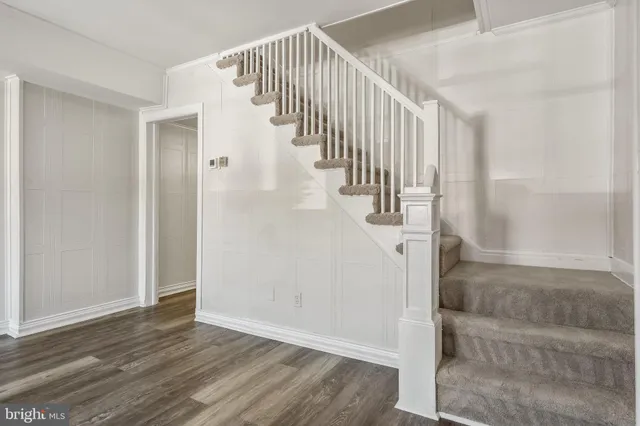 a view of entryway and hall with wooden floor
