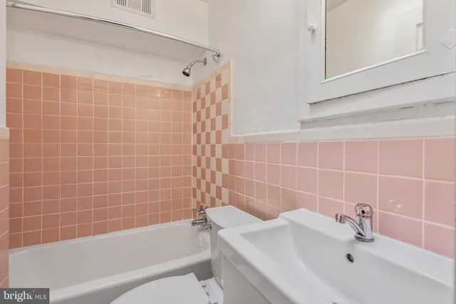 a bathroom with a bathtub and a sink