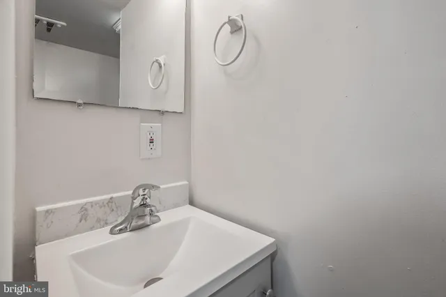 a bathroom with a sink and vanity