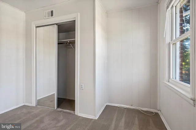 a view of hallway with window and front door