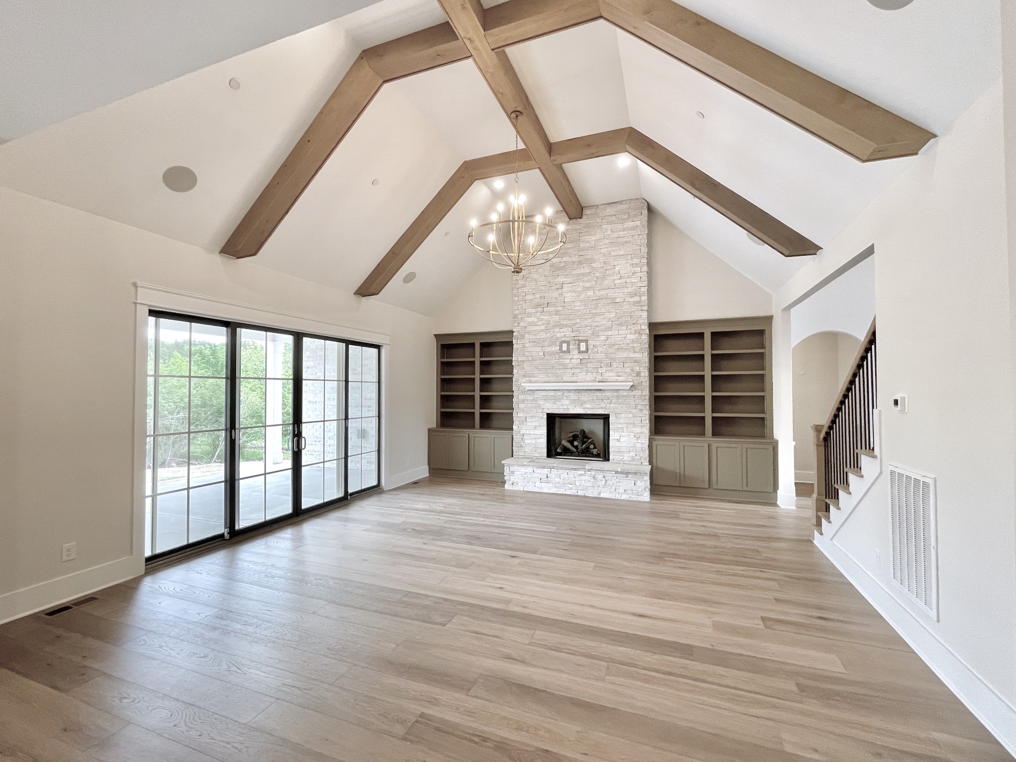 9926 Maupin Road Brentwood, TN 37027 - Photo 28 of 88 a view of an empty room with wooden floor windows and a fireplace