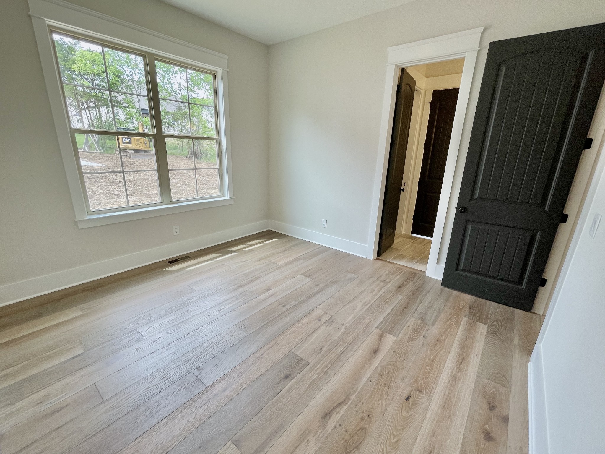 9926 Maupin Road Brentwood, TN 37027 - Photo 40 of 88 a view of an empty room with wooden floor and a window