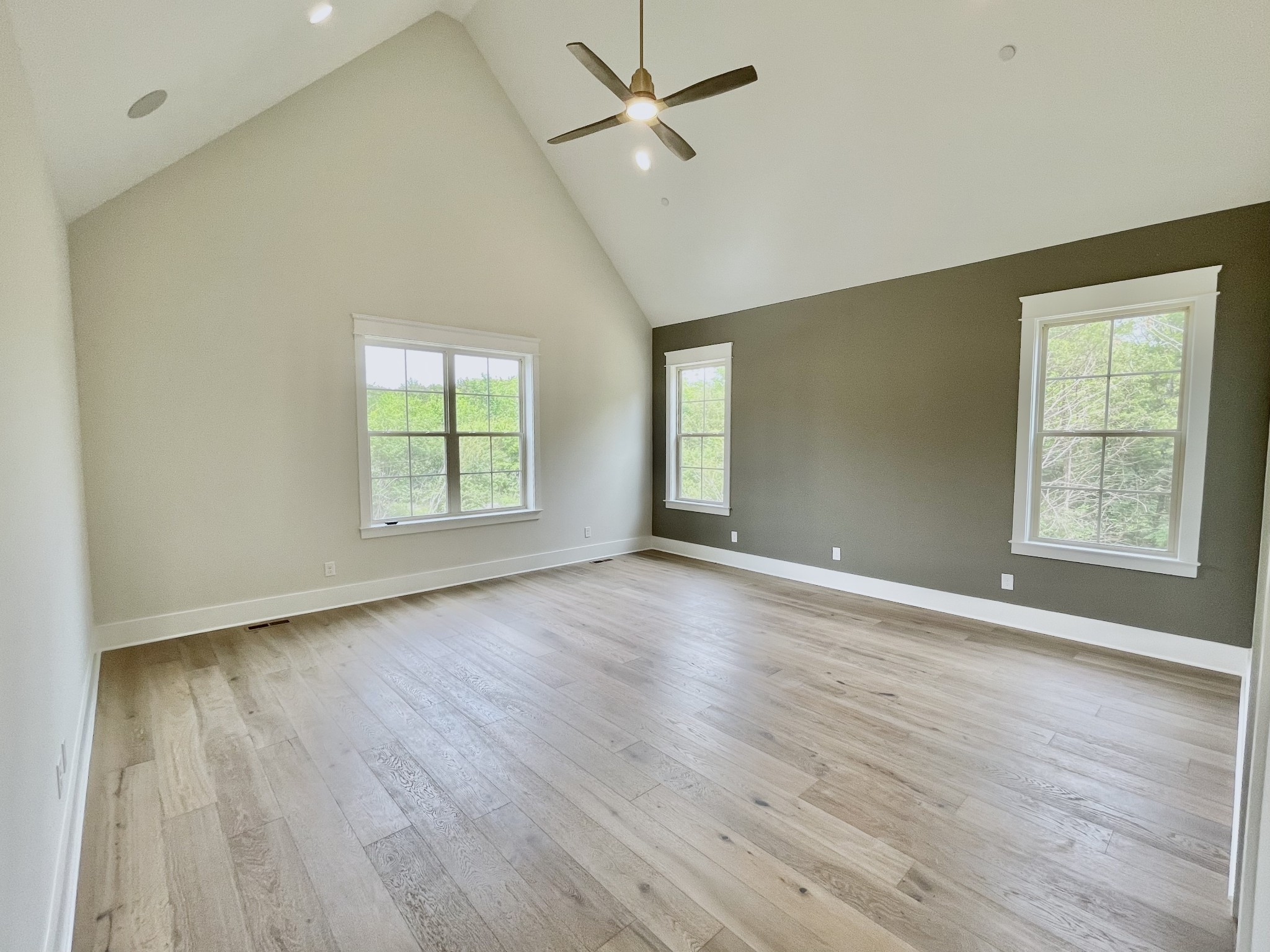 9926 Maupin Road Brentwood, TN 37027 - Photo 49 of 88 an empty room with wooden floor ceiling fan and windows